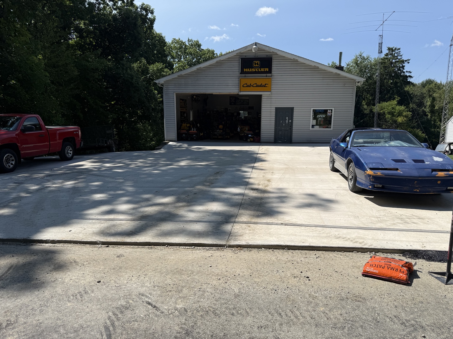 Large concrete apron in front of a commercial garage