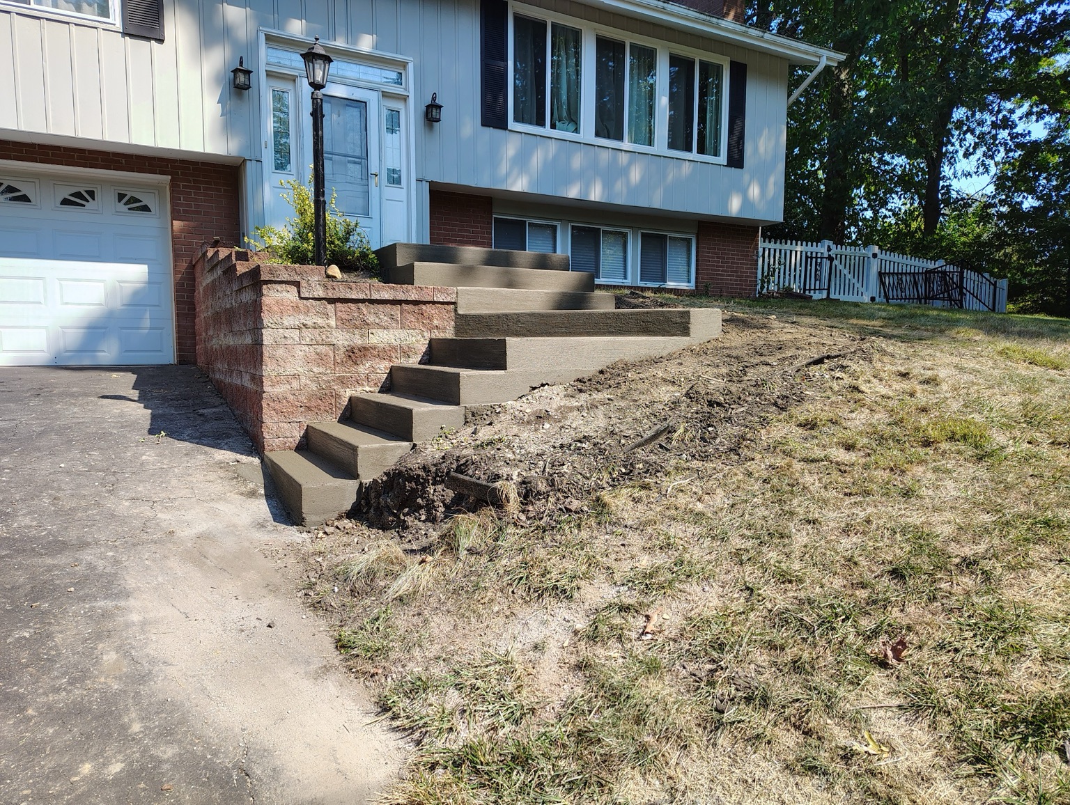 Concrete front steps with brick side walls