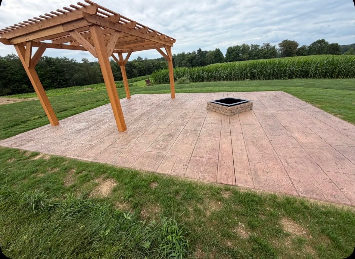Stamped concrete patio with wooden pergola and fire pit