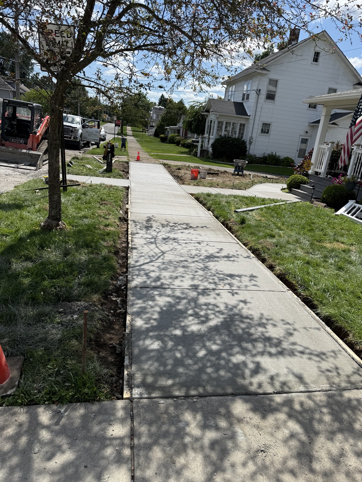 New concrete sidewalk along a residential street