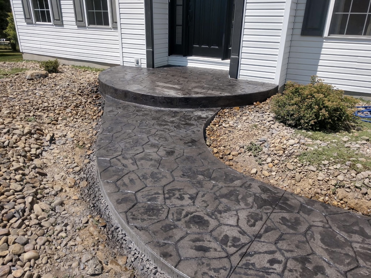 Stamped concrete walkway leading to a front entrance
