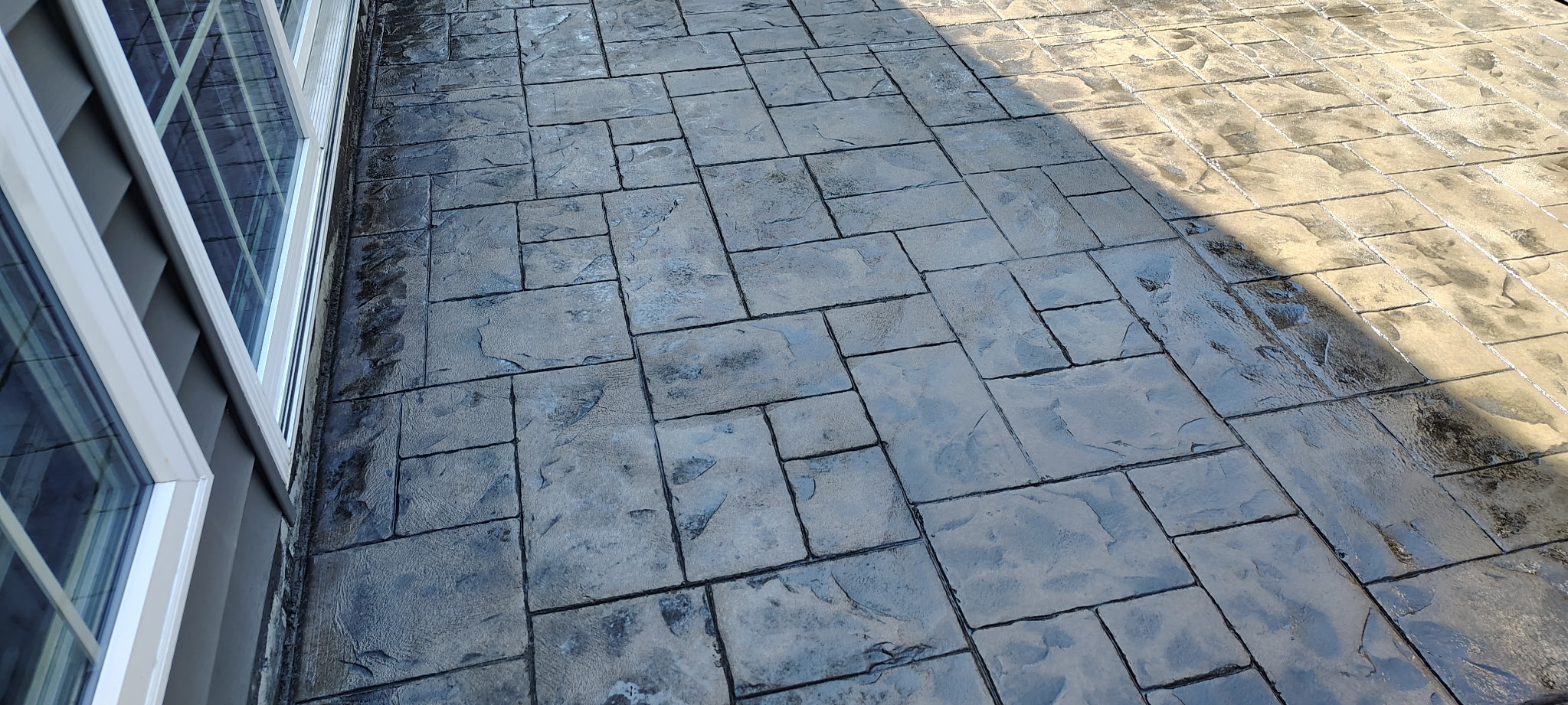 Stamped concrete patio beside a home